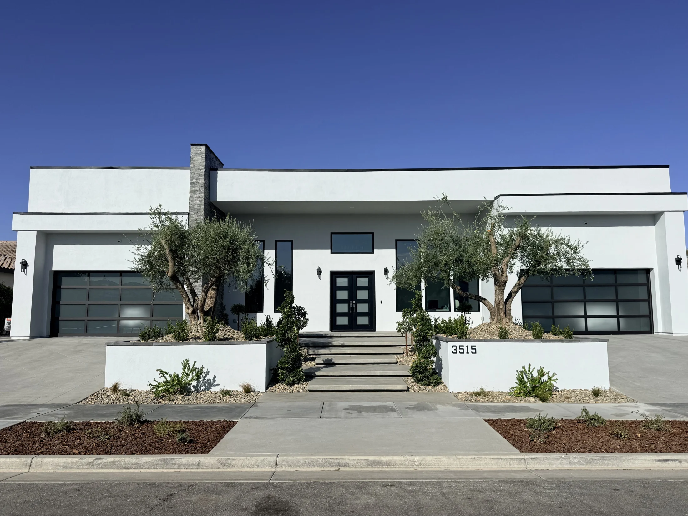 Modern Belcourt residence with a low horizontal roofline, courtyard entry and desert landscaping